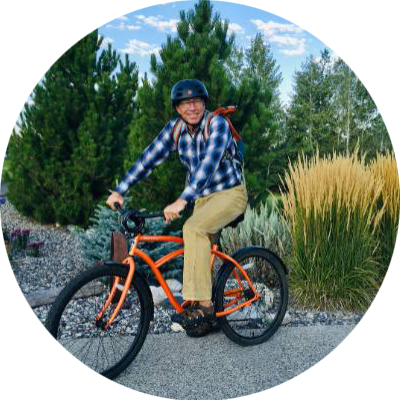 Photo of Dr. Brian Bothner. He is smiling at the camera while on a bike.
