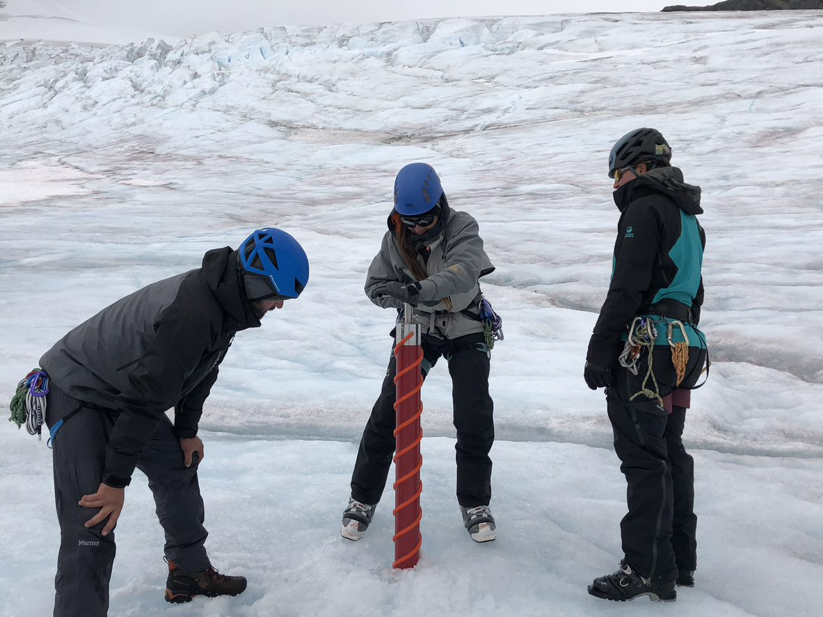 Image of one of our faculty members and their students at an artic sampling site.