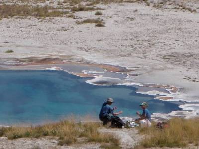Image of faculty member and student by hot spring.