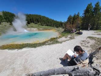 Oscar, a 2021 REU student, working by a thermal spring in Yellowstone National Park.