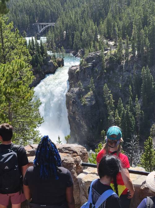 REU Students from 2021 cohort observing waterfall in yellowstone.