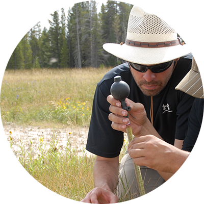 Photo of Dr.Matthew Fields. He is field sampling in Yellowstone.